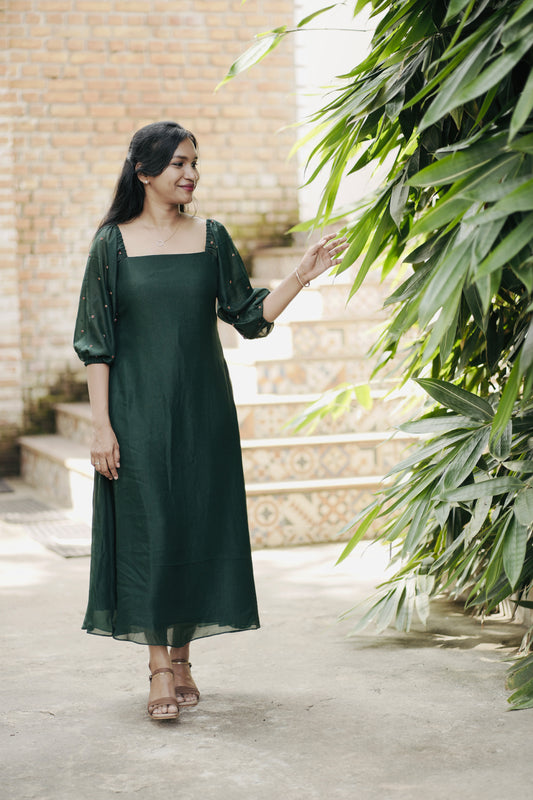 Emerald in emerald green showing aline dress and design