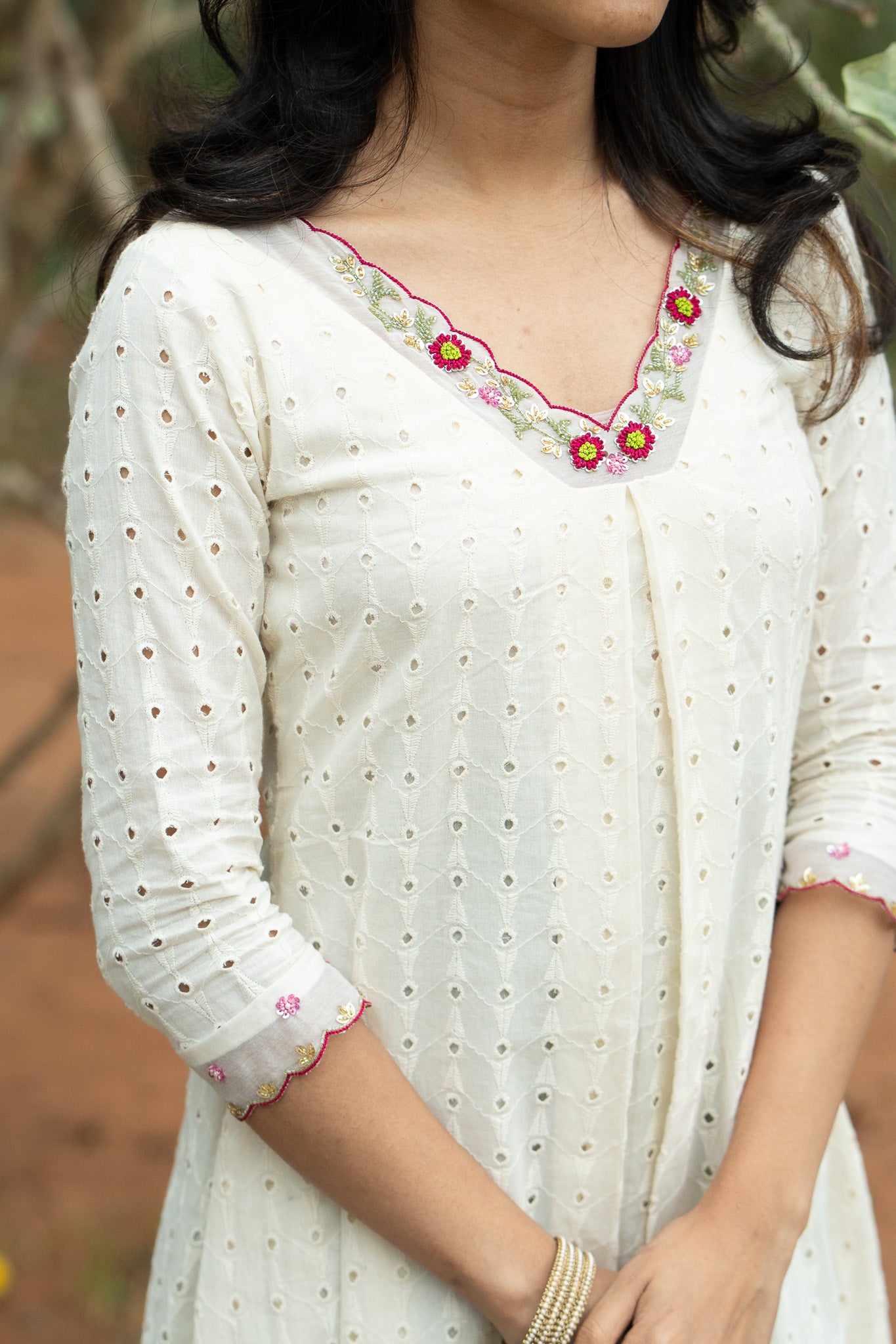 Pearl Bloom close-up of floral handwork on neck and sleeve ends detailing