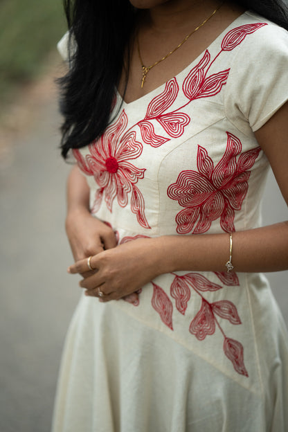 Serene in off white with red hand embroidery showing umbrella frock with special yoke pattern and design
