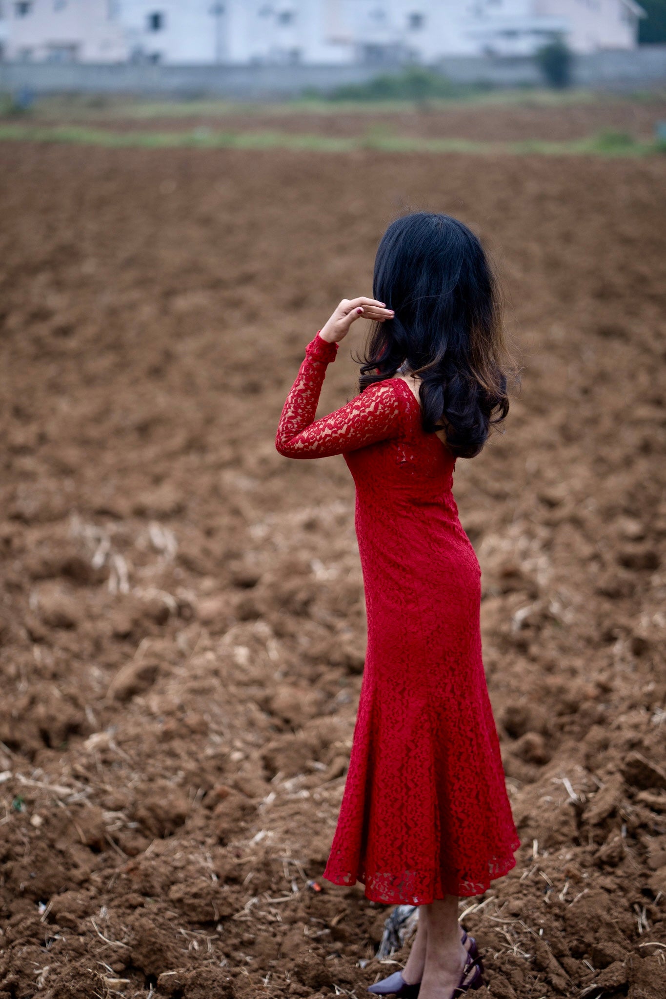 Scarlet red lace dress side view with figure-hugging bodice and flared hem