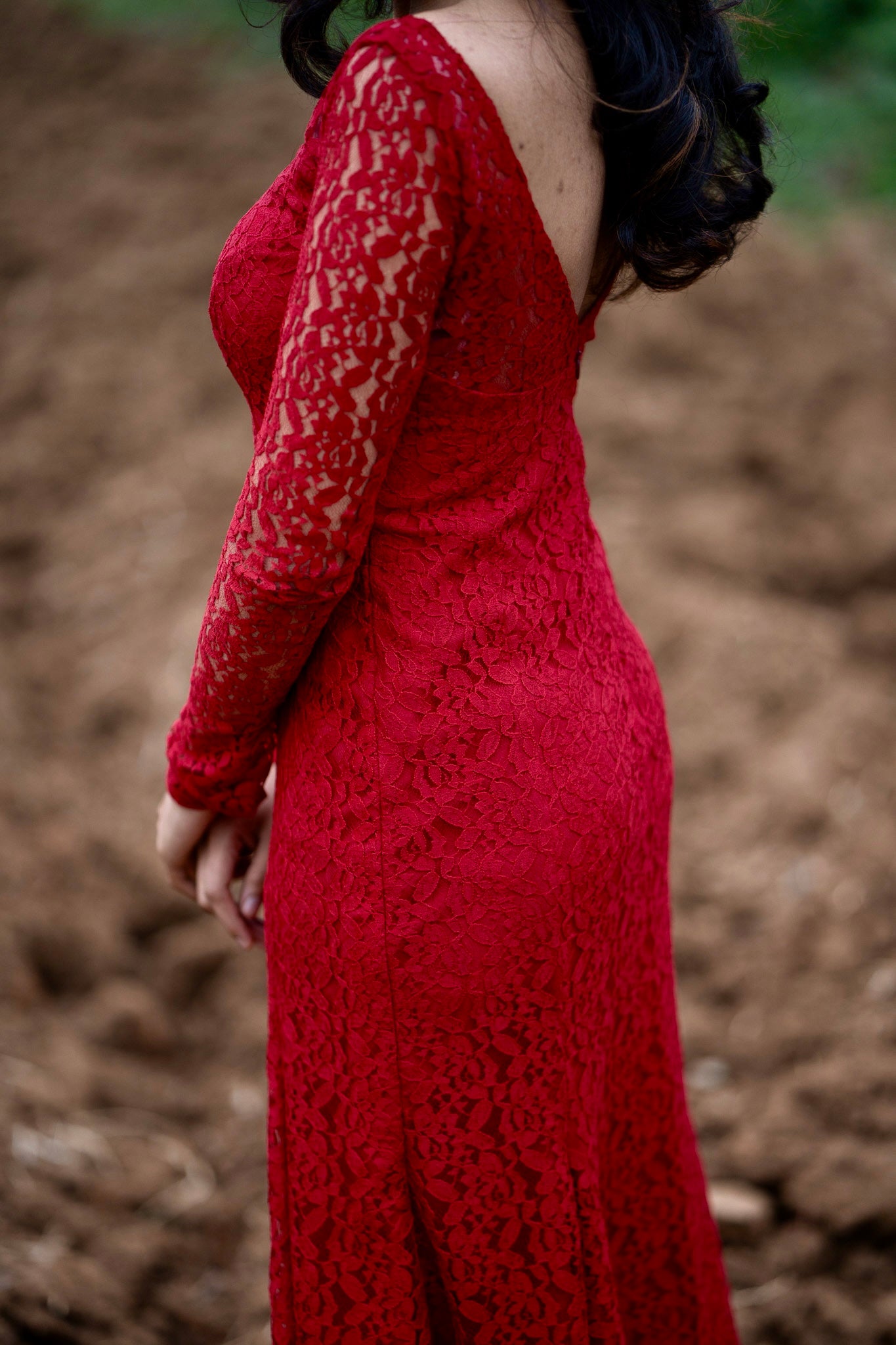 Scarlet red lace gown three-quarter angle showing sophisticated drape