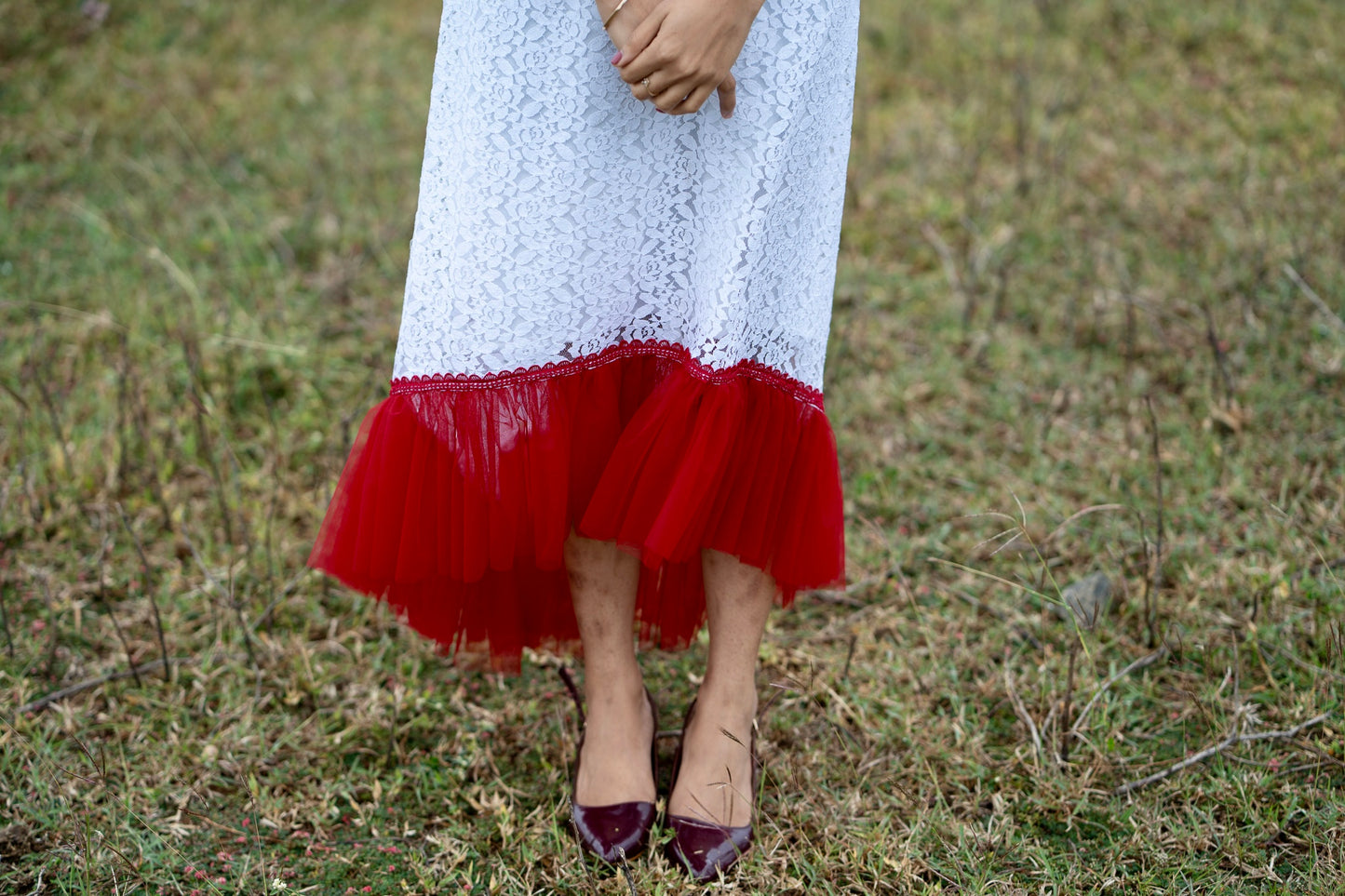 Roselle side view showing flowing aline dress with red net gathers at the hem