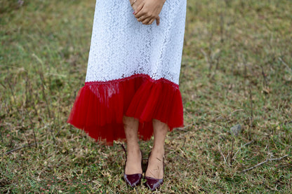 Roselle side view showing flowing aline dress with red net gathers at the hem