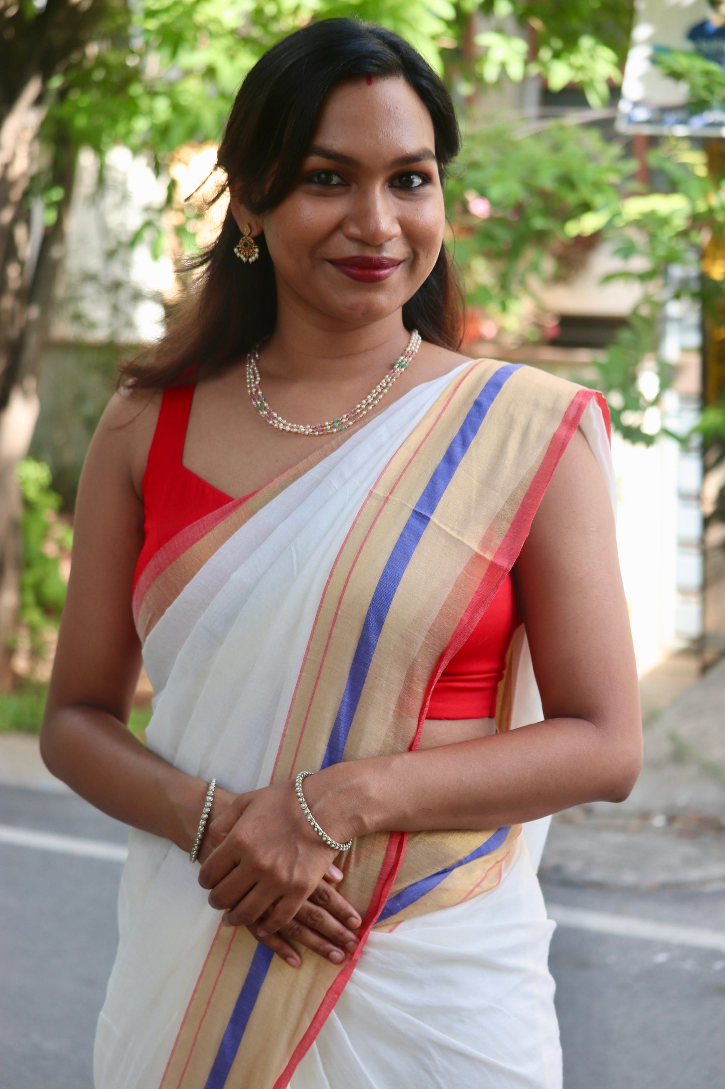 Vaidehi – Off White Mul Cotton Kerala Saree with Gold, Blue & Red Border