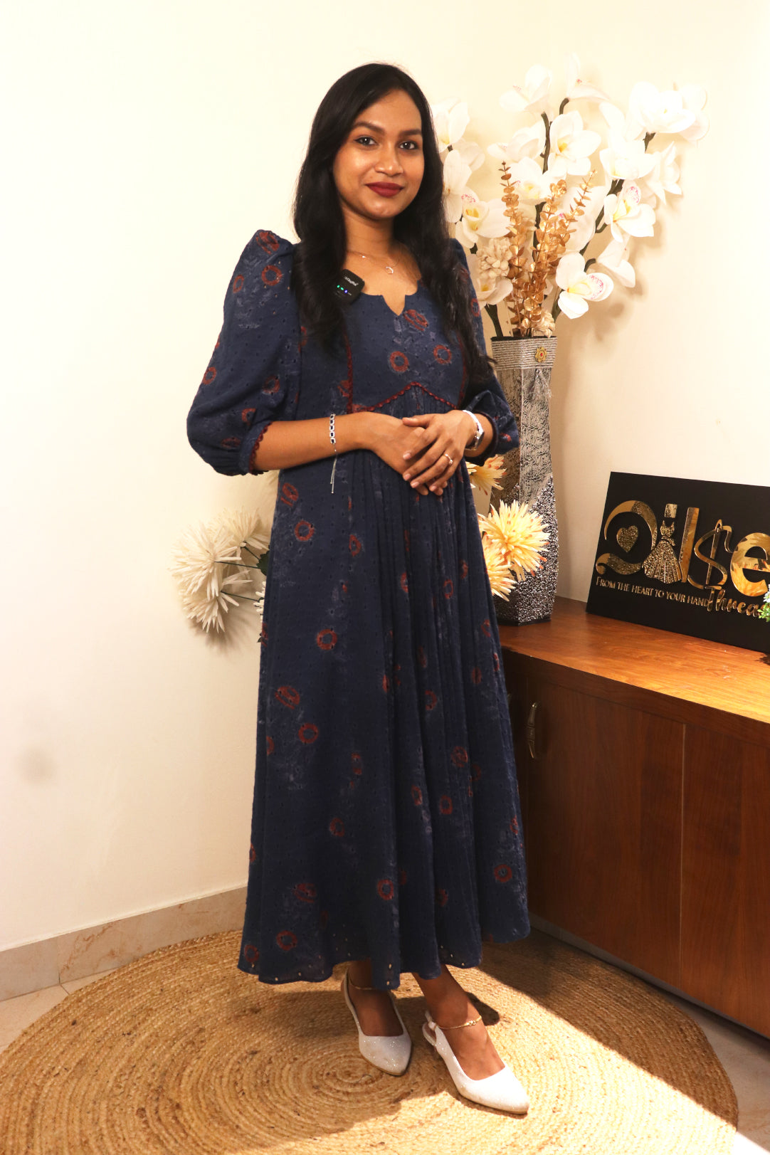 Woman wearing Indiraa hakoba block print kurti in navy blue with 3/4 sleeves standing in modern interior