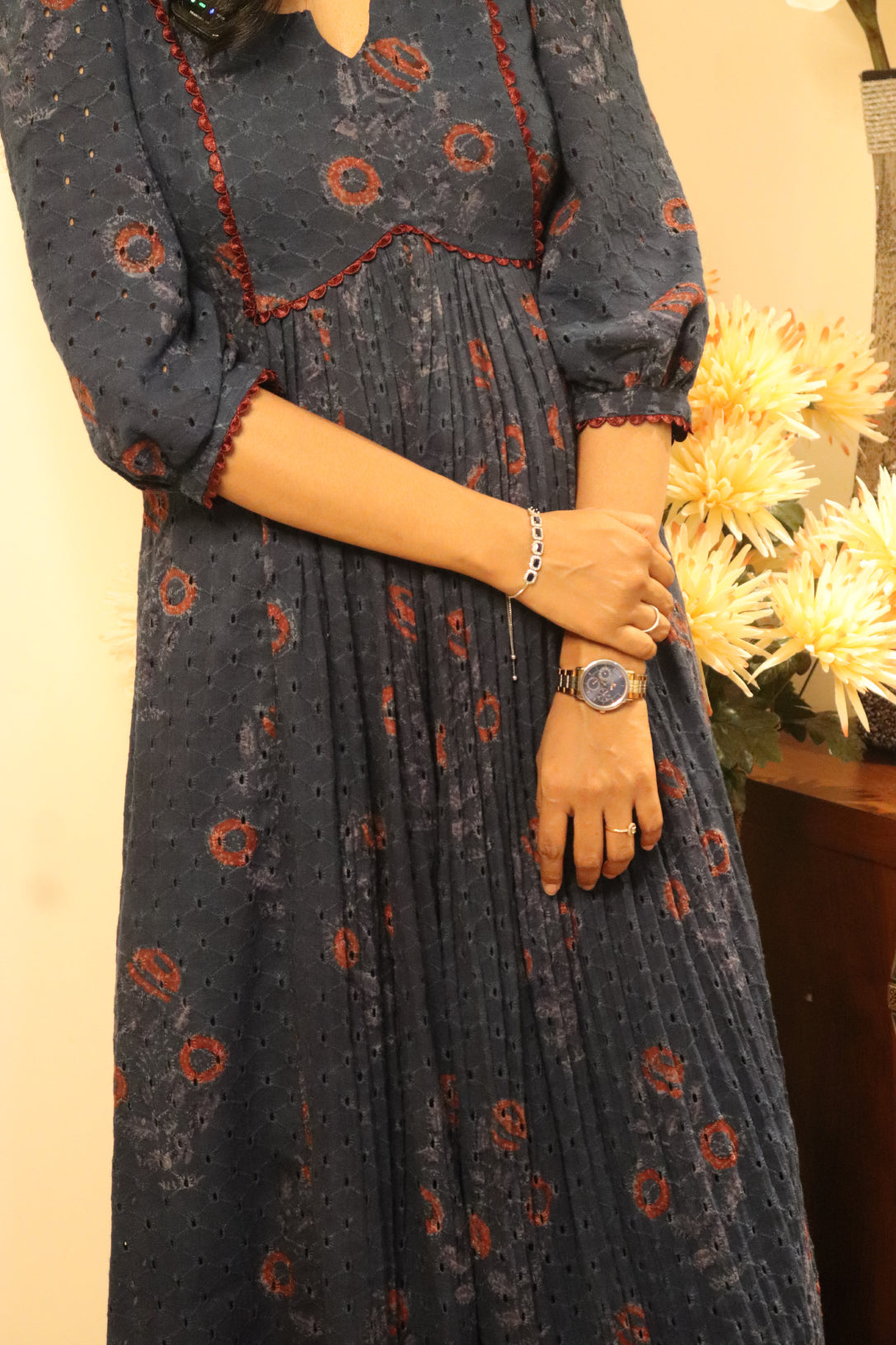 Close-up detail of Indiraa kurti showing hakoba block print with red floral pattern and fabric gathering