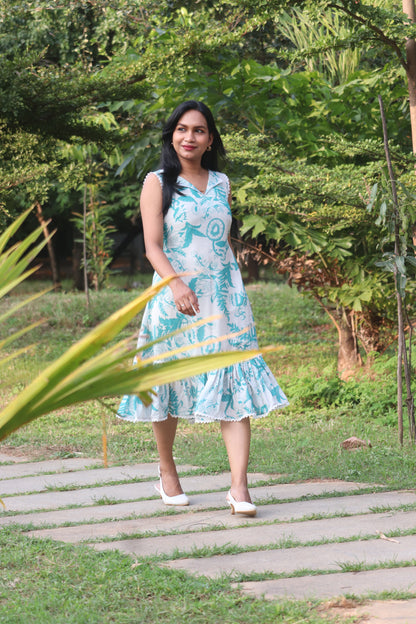 Petal linen A-line dress in Aija Blue floral print standing outdoors on garden path