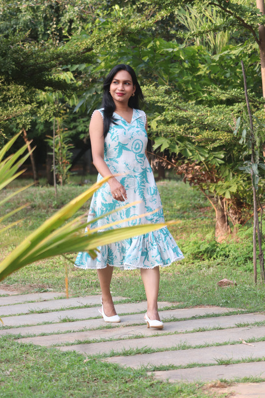 Petal linen A-line dress in Aija Blue floral print standing outdoors on garden path