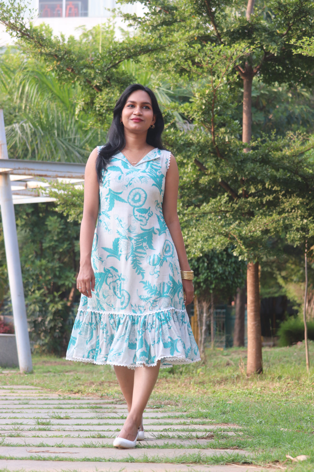 Petal dress front view with V-neckline and Aija Blue floral print on linen fabric with ruffled hem