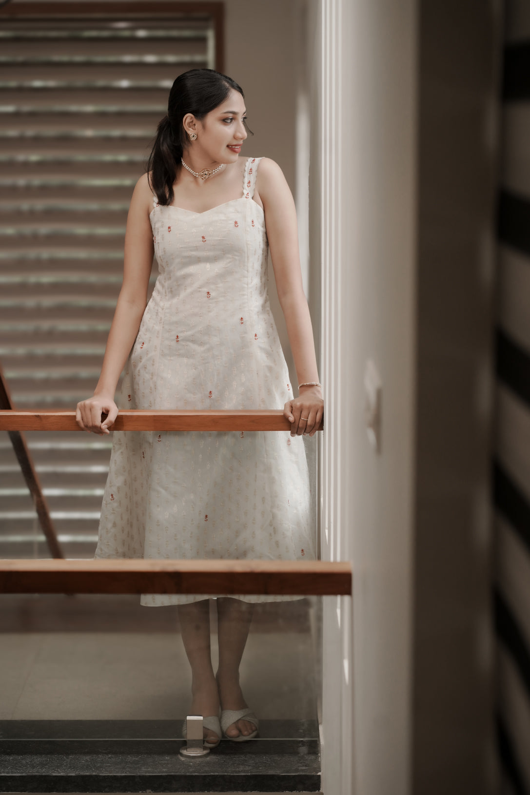 Aarohi off-white Chanderi dress full-length view on staircase with embroidered details