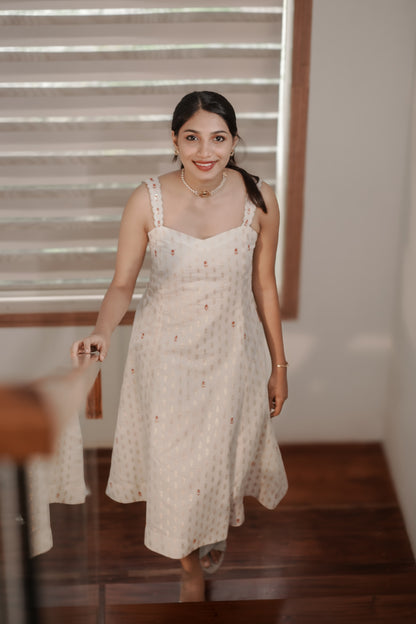 Woman wearing Aarohi Chanderi dress with embroidered details indoors
