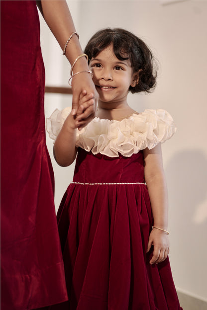 Daughter wearing red and white off-shoulder umbrella dress with ruffle neckline
