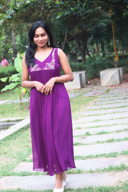 Woman wearing Viola dark purple viscose georgette kurti, standing on a pathway with greenery, showing full-length centre gathered anarkali silhouette