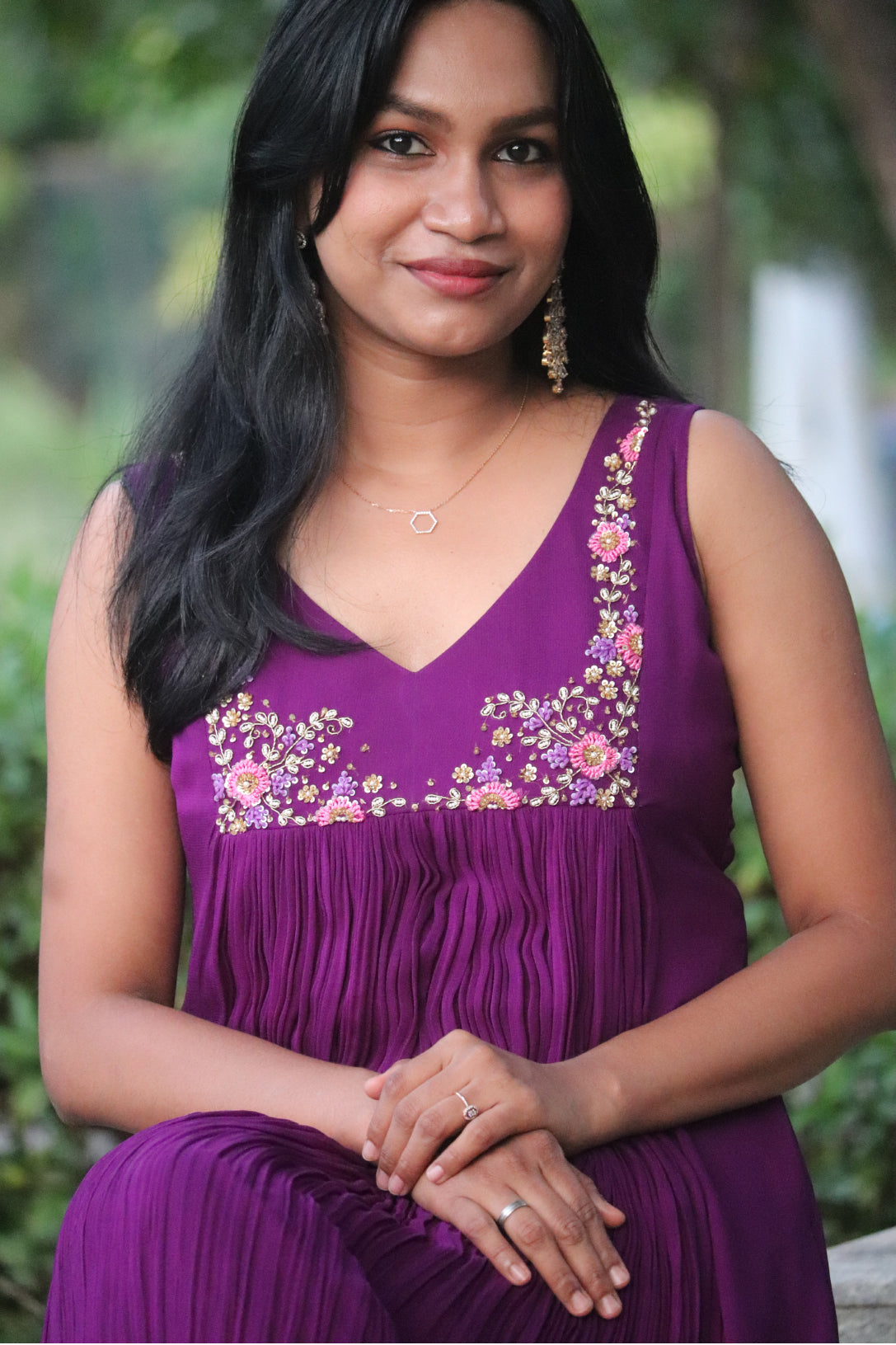 Woman wearing Viola dark purple viscose georgette kurti with handwork embroidery on the yoke, sleeveless with curved V neck
