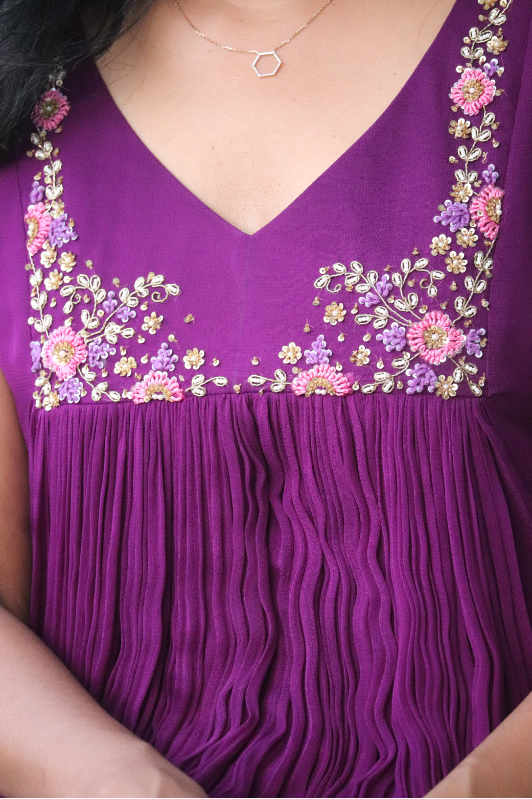 Close-up of Viola dark purple kurti showing detailed floral handwork embroidery on the curved V-neck yoke in pink, purple and gold tones