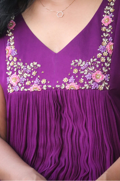 Close-up of Viola dark purple kurti showing detailed floral handwork embroidery on the curved V-neck yoke in pink, purple and gold tones